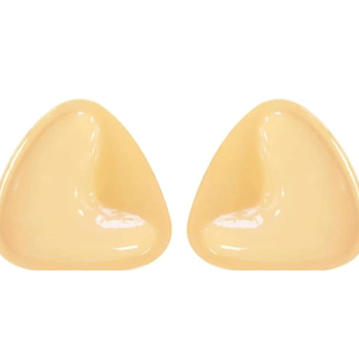 A pair of nude-coloured, triangular padded lift pads on a light background