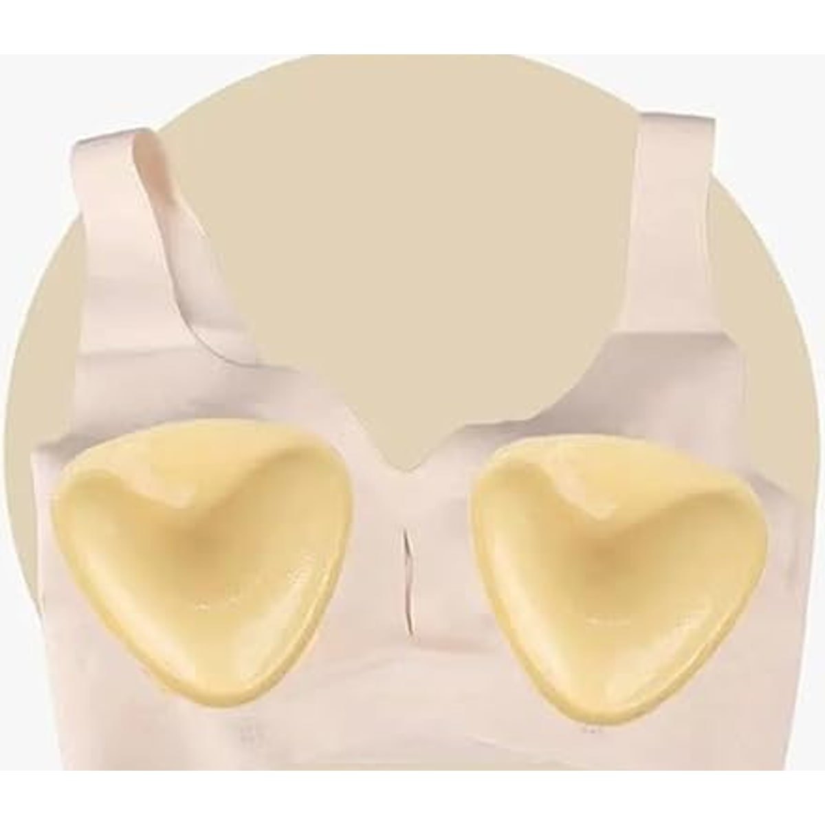 Both pads pressed into the cups of a light pink bra top
